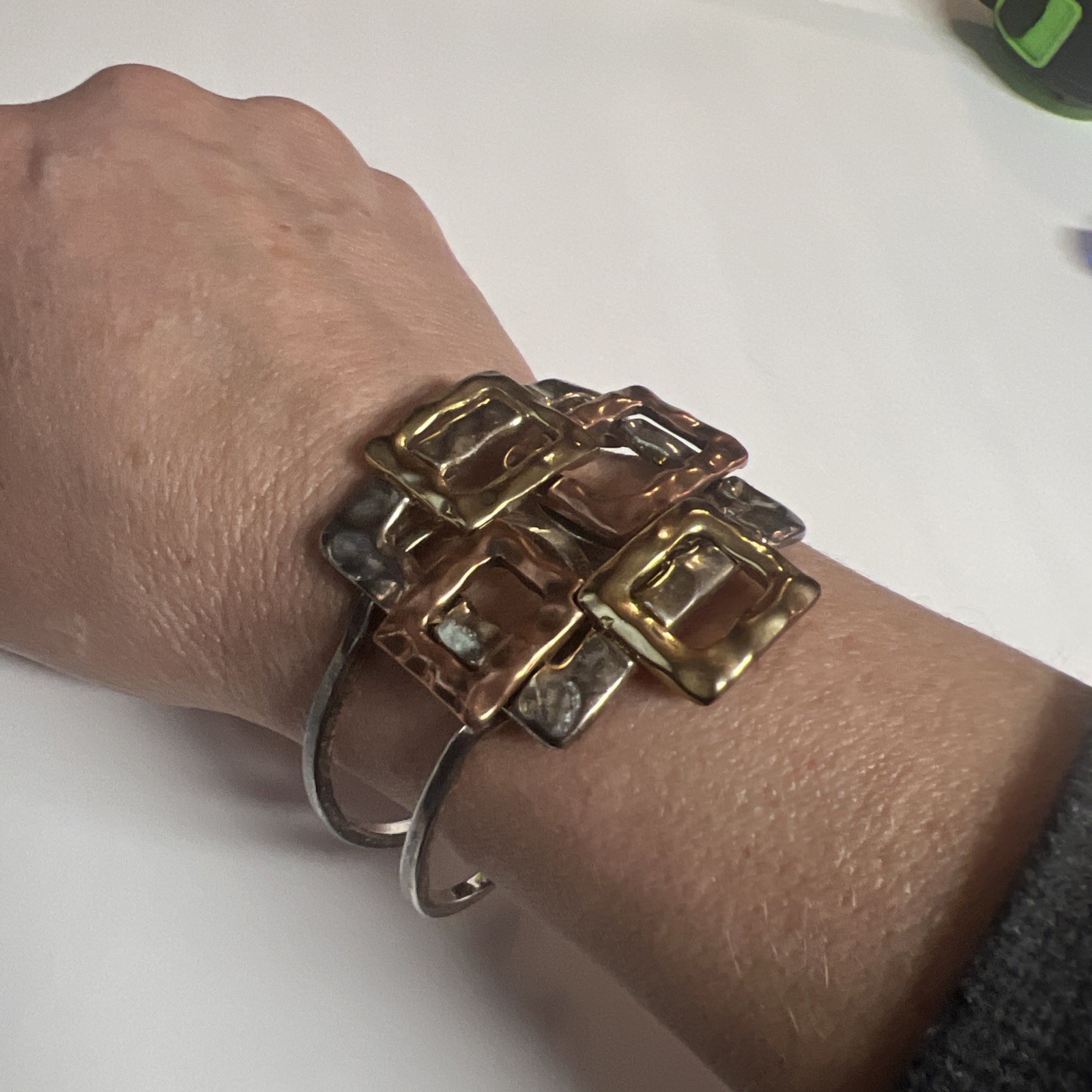 Brutalist mixed metal cuff bracelet, geometric silver and gold tone squares.
