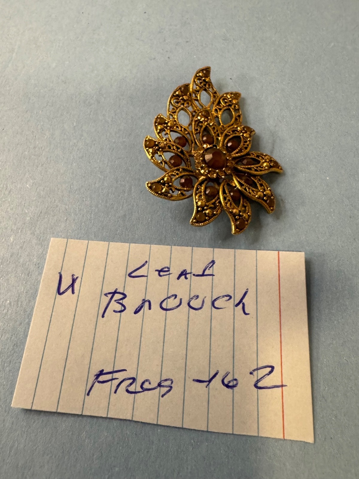 Gold Tone Brooch with Amber and Brown Glass Stones In A Floral or Leaf Design
