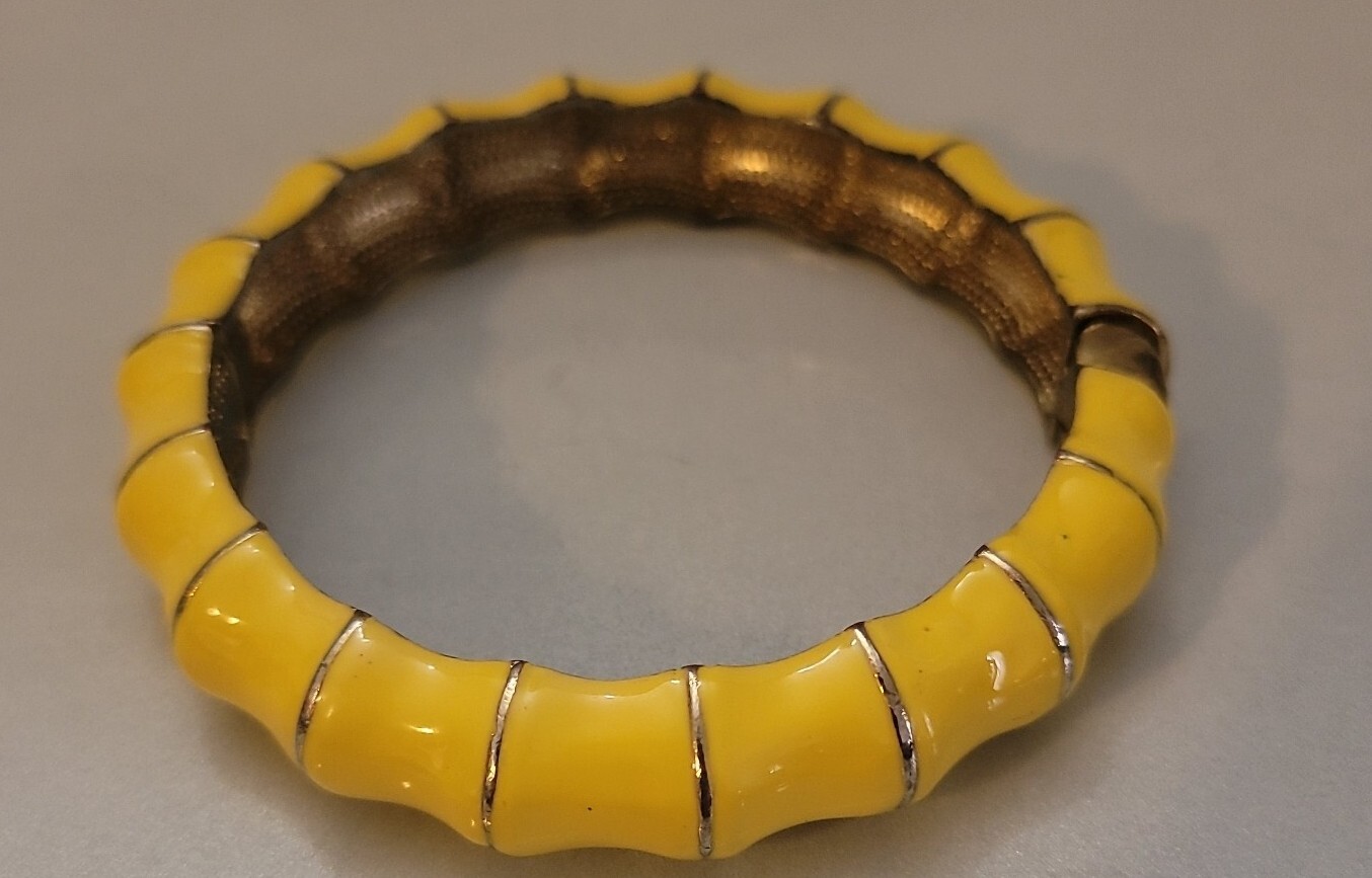 Hinged clamper Yellow bracelet on shapely goldton jewelry