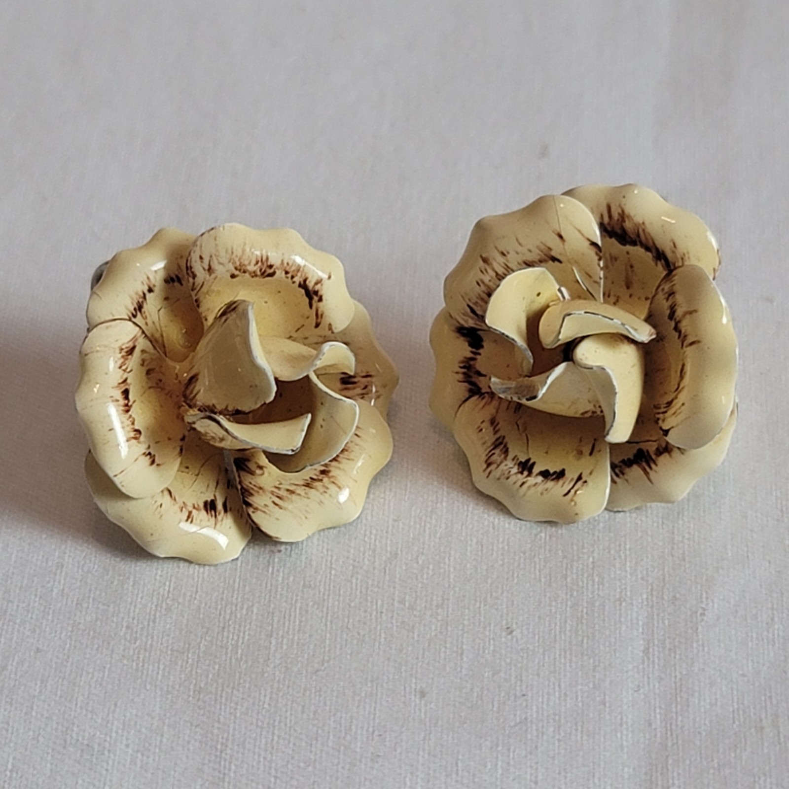 vintage floral clip-on earrings and brooch with a cream and brown enamel finish