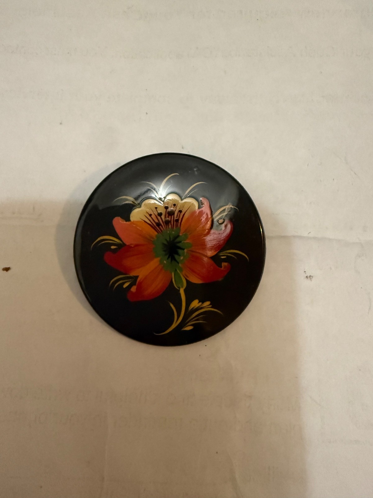 Soviet-era brooch features Cyrillic lettering.