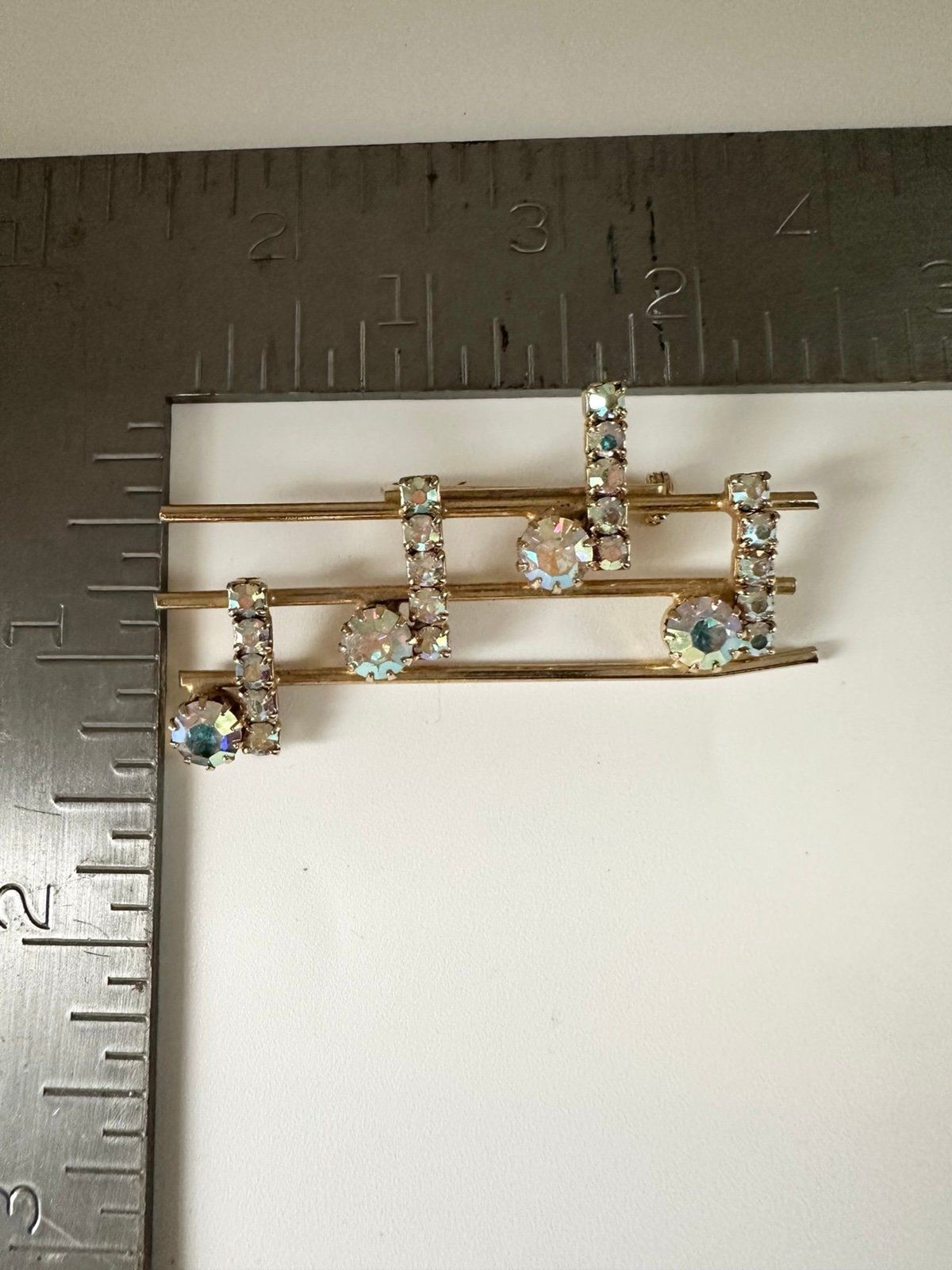Vintage gold tone rhinestone music notes brooch