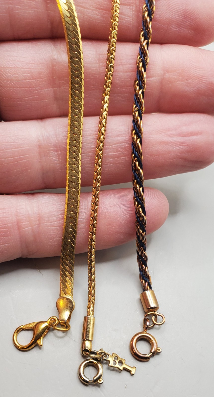 3 Vtg Chains: Trifari 24″, Herringbone 20″, Gold Tone & Black Twisted Rope 30″