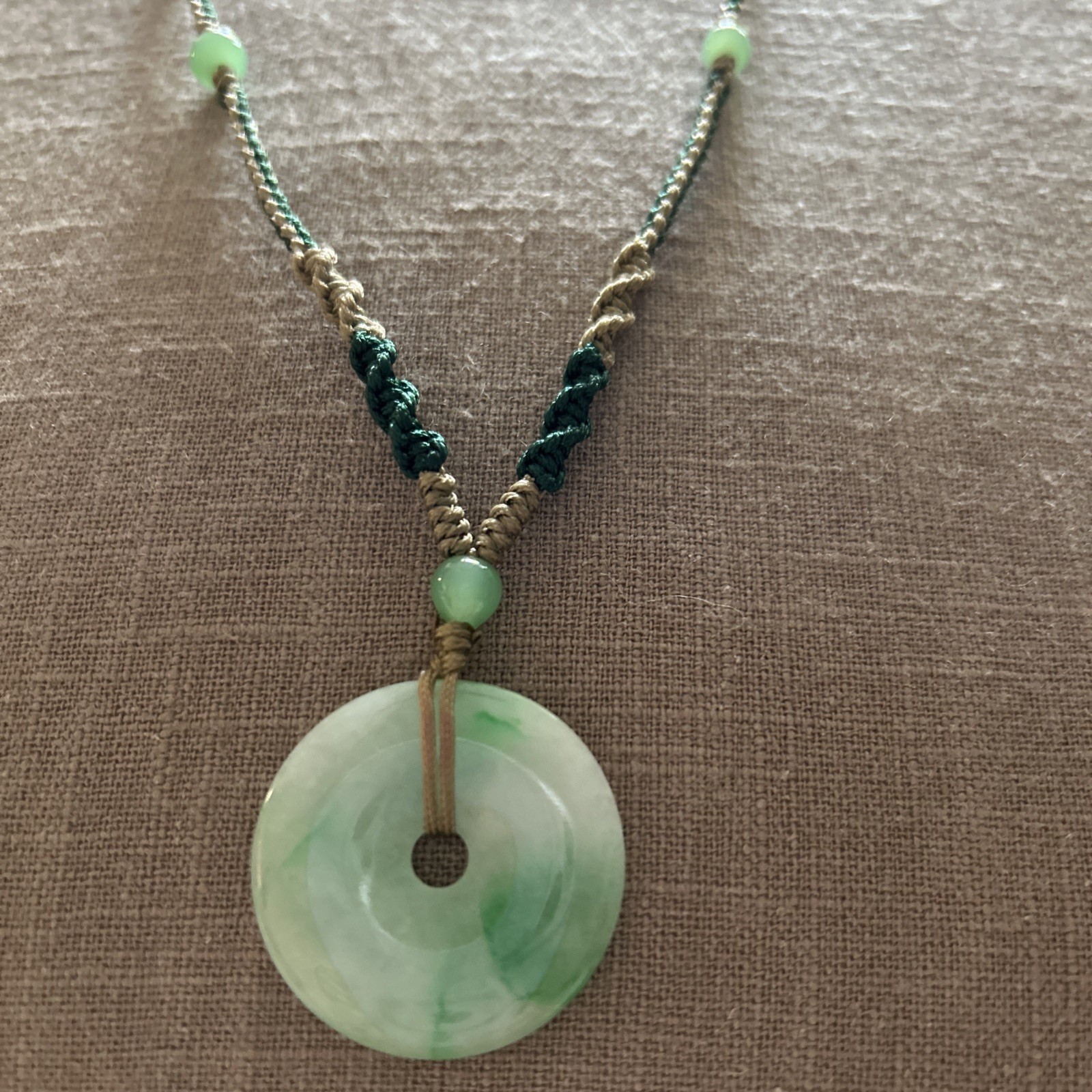 Vintage Green Jade Pendant 1-1/8” on a braided tan and green cord w/3 jade beads