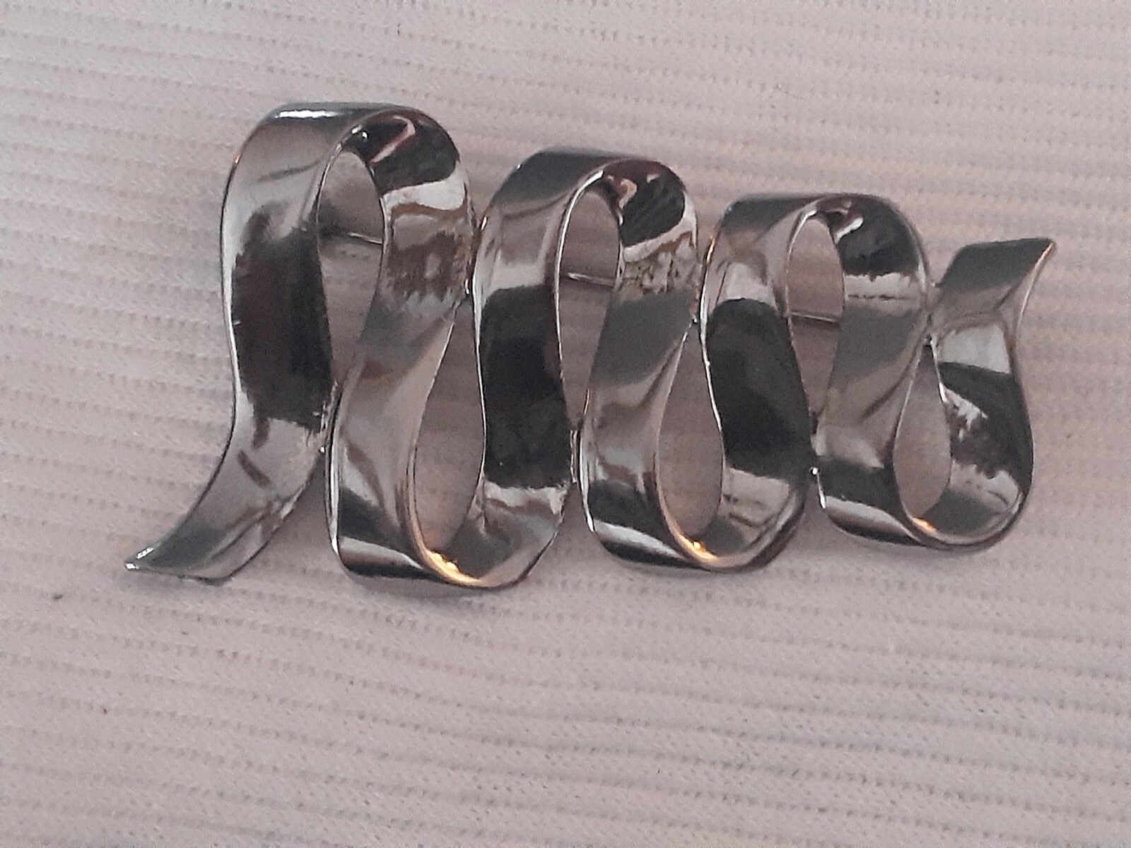 Vintage M Jent polished silvertone Swirl ribbon design Brooch/pin