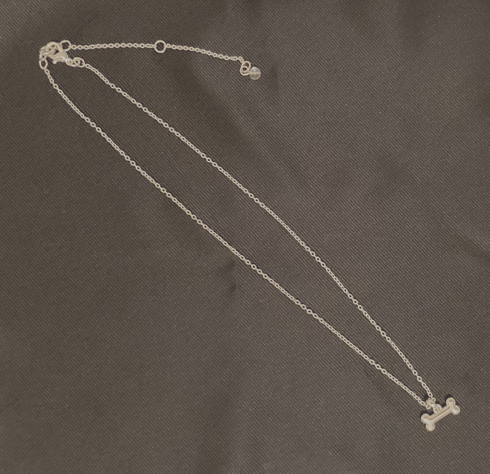 NAPIER Women’s Silver 16″-18″- 20″ Adjustable Necklace w/1/2″ Crystal Dog Bone